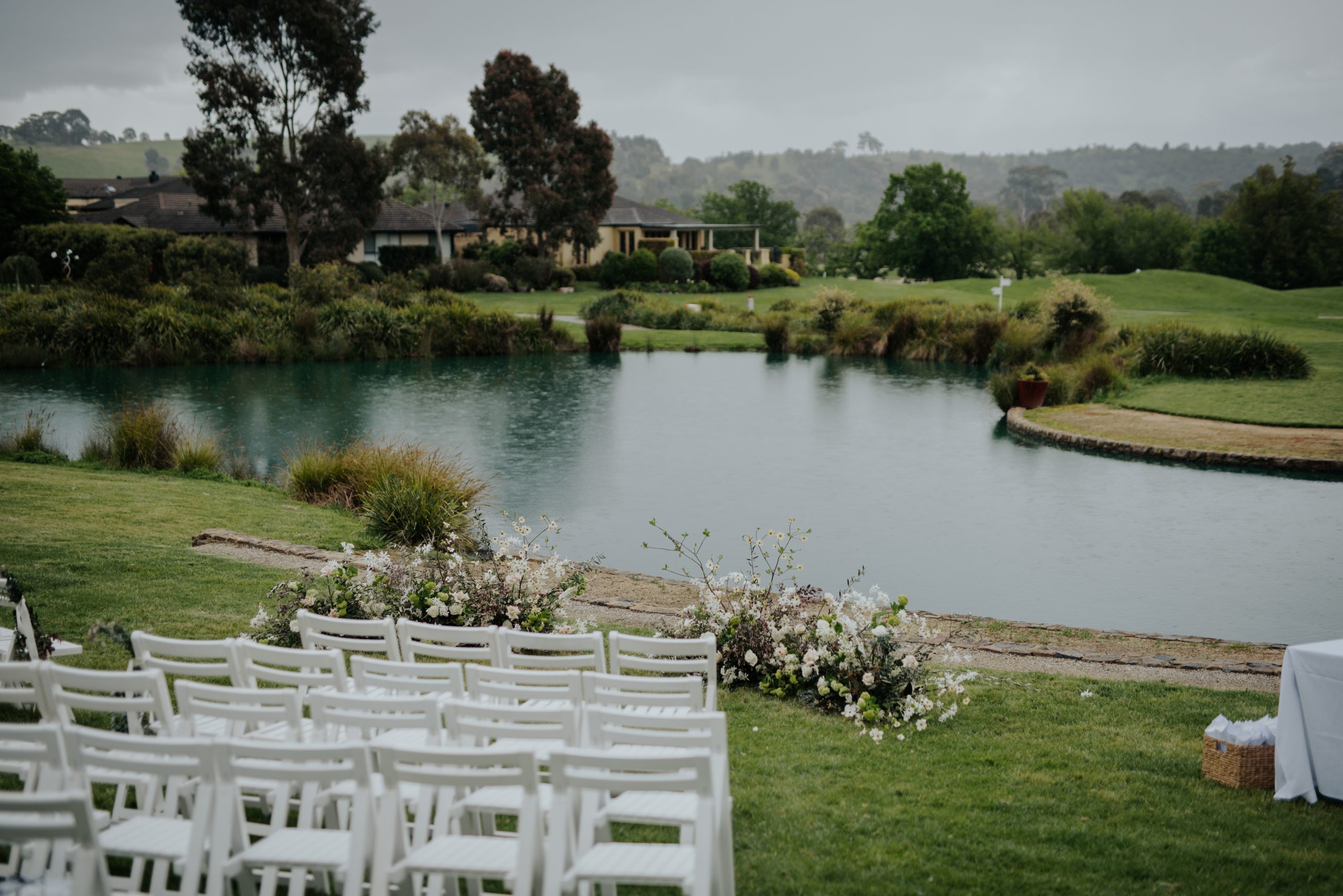 View over the lake with wedding ceremony set up