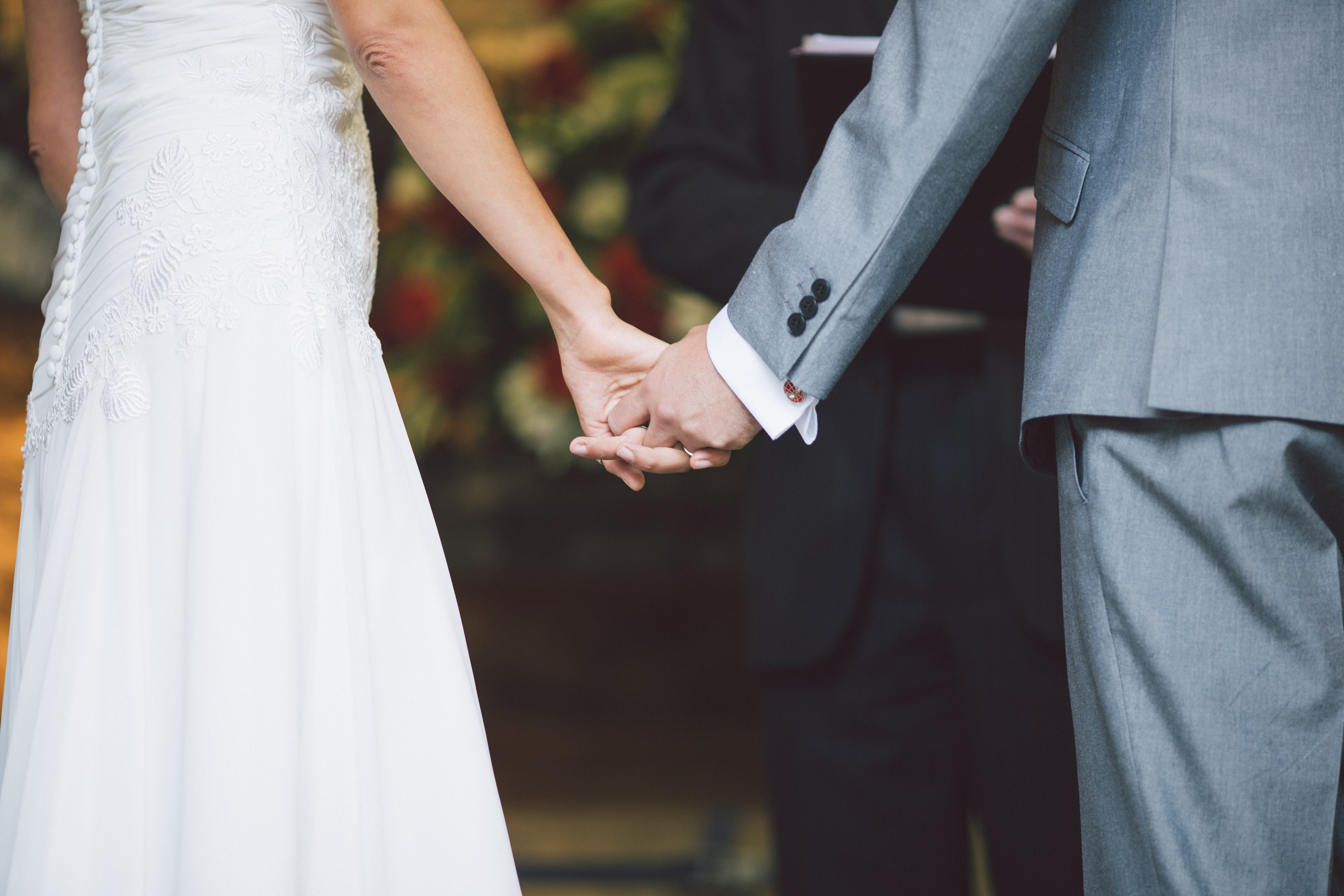 Wedding couple holding hands.